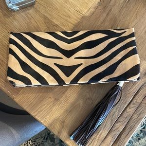 TUMI, Pony Hair, leopard skin clutch. Brown leather trim. 13” w x 6” h.